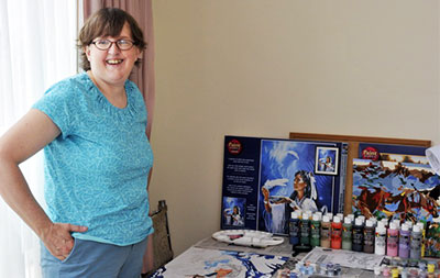 Darlene showing her paintings