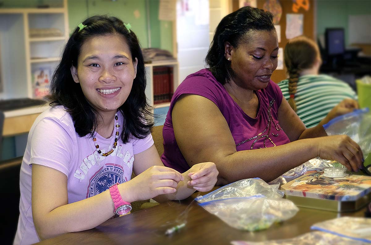 two women doing crafts together at St. Bernards program