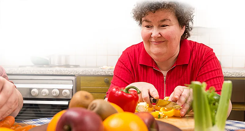 woman with disability preparing food in her kitchen