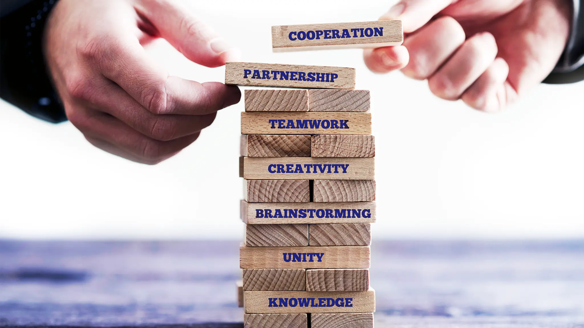 stacking blocks of cooperation, partnership and teamwork